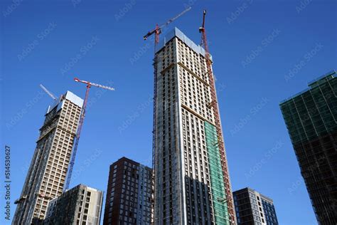 High-rise buildings under construction against a clear blue sky ...