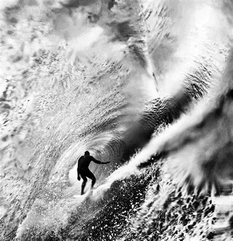 a man riding a wave on top of a surfboard