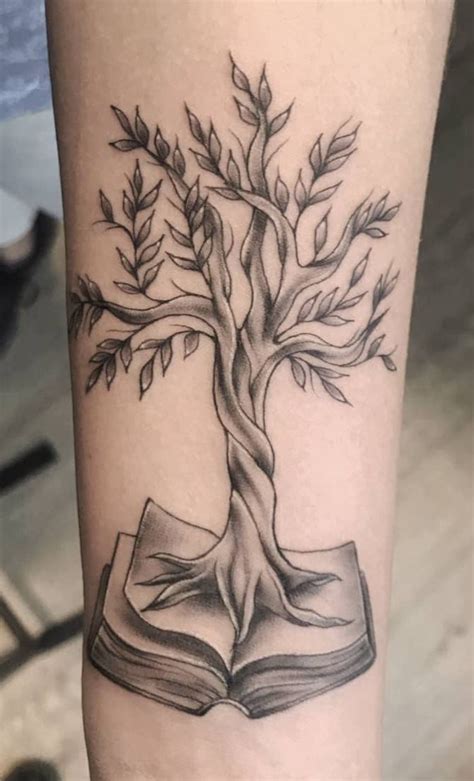a tree on top of an open book tattoo