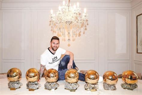 Lionel Messi and his family pose with his seven Ballon d'Or awards in ...