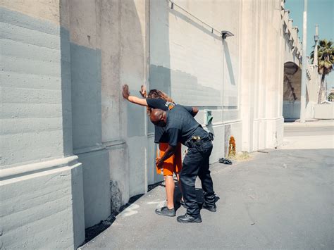 An Officer Frisking a Man · Free Stock Photo