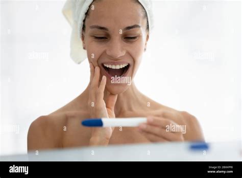 Head shot excited woman surprised by pregnancy test result Stock Photo - Alamy