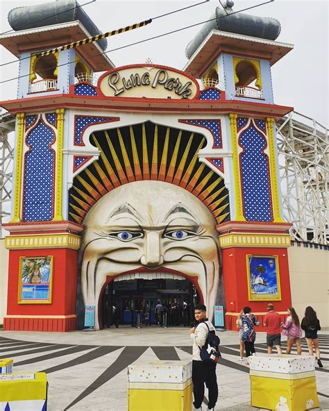 the entrance to luna park with people standing in front and looking at something behind it