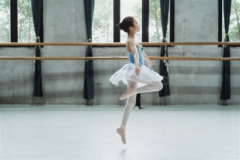 Ballerina girl in tutu skirt jumping in ballet school · Free Stock Photo