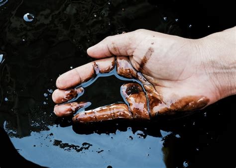 Premium Photo | Crude oil in hand due to crude oil leak. oil ans gas process