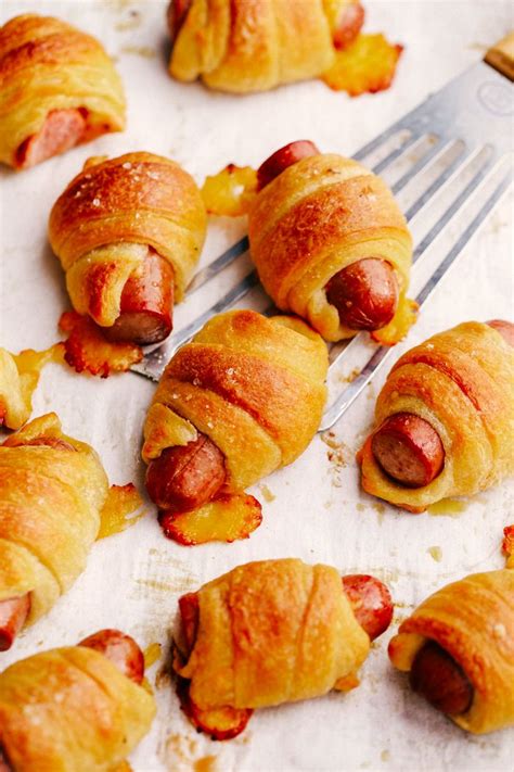 Cheesy Pigs in a Blanket. The perfect appetizer for your tailgaiting or holiday fun. Hot dogs ...