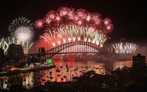 Fireworks explode over the Sydney Harbour Bridge during the midnight display on New Year’s Eve ...