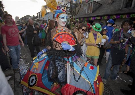 A reveler wearing a tent as a costume dances during Mardi Gras ...