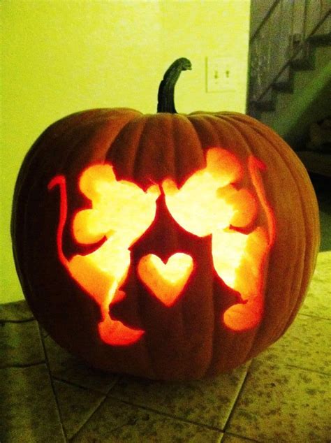 a carved pumpkin with hearts on it