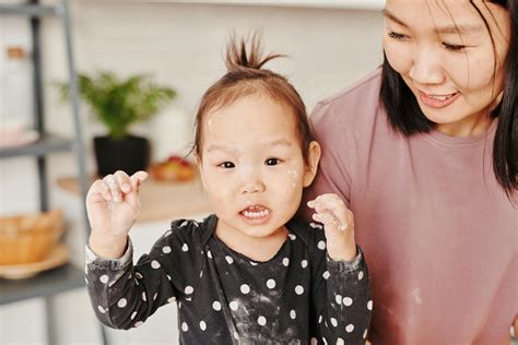 A Cute Child With Flour on Her Face and Hands · Free Stock Photo