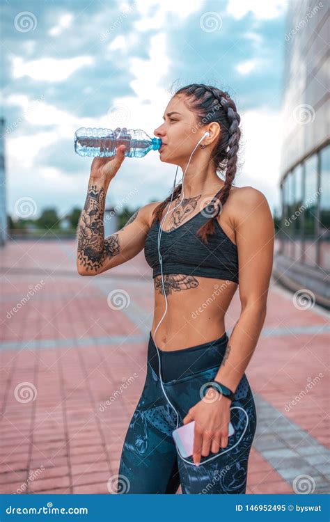 Woman Athlete in Tattoos, Summer City, Resting after Workout Fitness ...