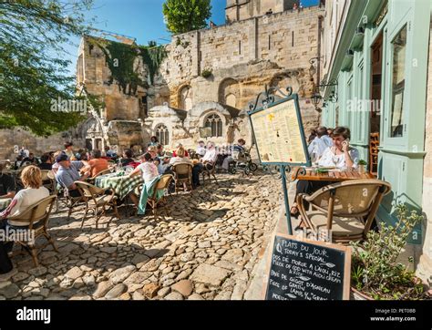 SAINT EMILION alfresco restaurant restaurants blackboard 'menu of the day' and diners cobbled ...