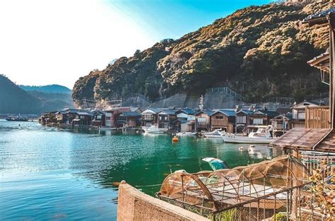 a body of water surrounded by mountains and houses