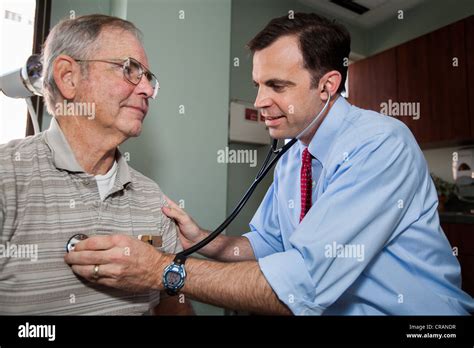 A doctor listens to a patient's lungs Stock Photo - Alamy