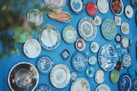 Decorative ceramic plates on blue wall · Free Stock Photo