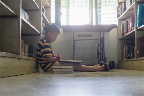 Boy reading in a library 2159206 Stock Photo at Vecteezy