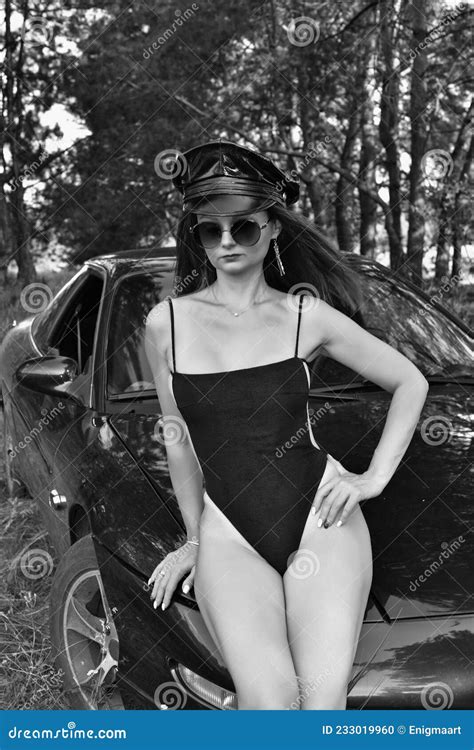 Young Woman in a Swimsuit Driving a Sports Car. Stock Photo - Image of black, machine: 233019960