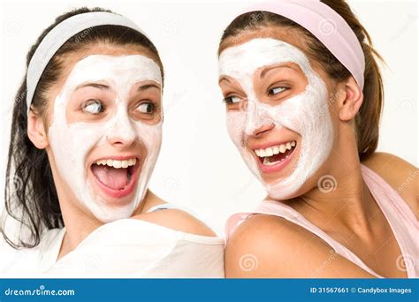 Cheerful Girls Having Facial Mask And Laughing Stock Image - Image: 31567661