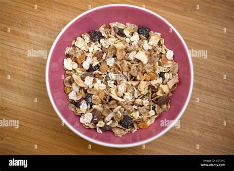 A pink bowl of muesli with dried fruit Stock Photo - Alamy