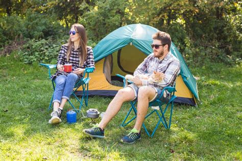 People, Tourism and Nature Concept - Couple Having Fun on Camping Trip Stock Photo - Image of ...