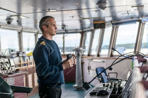 Premium Photo | Deck officer with binoculars on navigational bridge ...