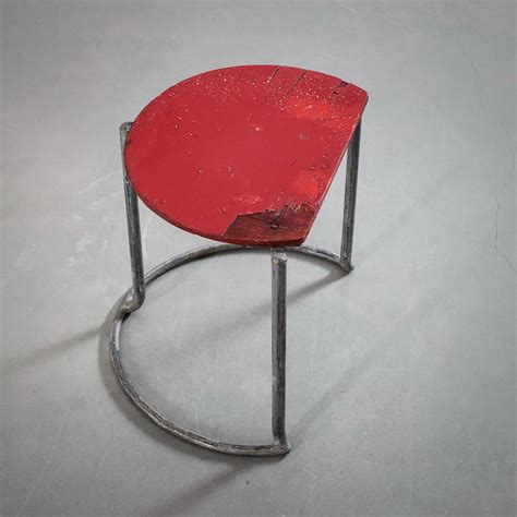 Alvar Aalto | A circular black side table with red table top and an intermediary shelf | MutualArt