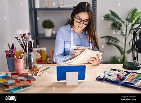 Young woman artist using touchpad drawing on notebook at art studio Stock Photo - Alamy