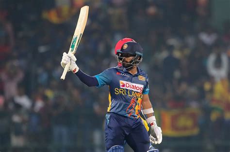 Kusal Mendis raises his bat after completing a half-century ...