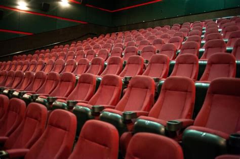 Premium Photo | A movie theater with red seats and green seats.