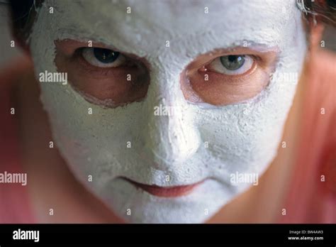 Woman, mother at dining room table close up with facial mask looking into camera Stock Photo - Alamy