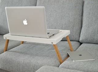 silver MacBook on laptop table on sofa - Credit to https:/… | Flickr