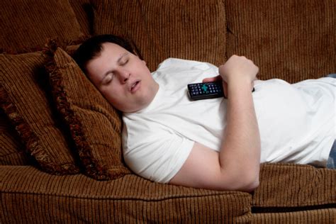 Man Sleeping On The Couch Holding The Remote Control Stock Photo - Download Image Now - iStock