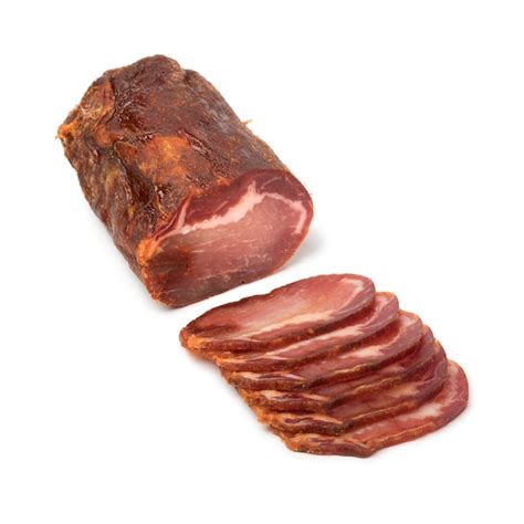 Premium Photo | Piece of spanish lomo embuchado meat and slices isolated on white background