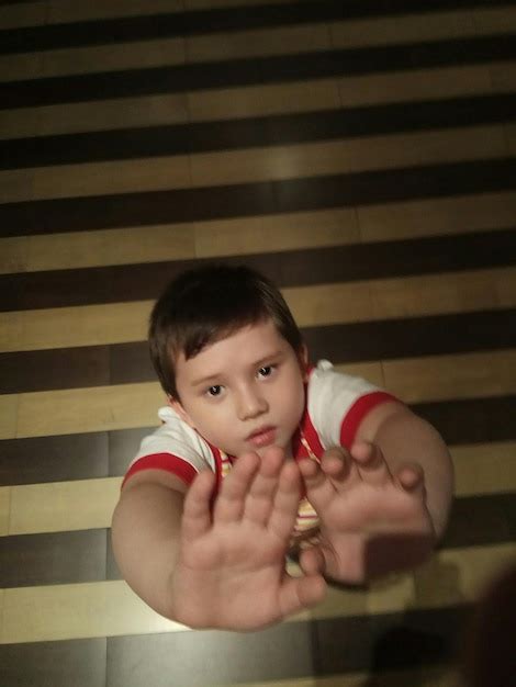 Premium Photo | Portrait of boy gesturing stop sign at home
