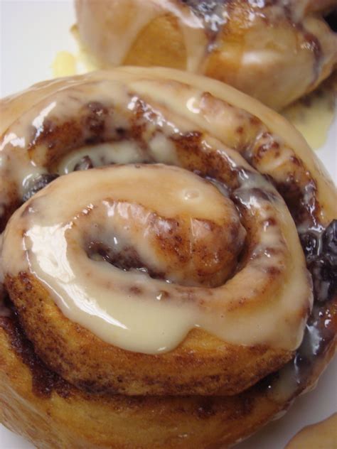 Freshly baked Cinnamon Roll glazed with orange icing | Breakfast sweets, Cinnamon roll glaze, Bakery