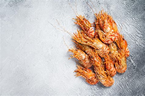 Premium Photo | Raw greenland prawn shrimp on a kitchen table. white ...