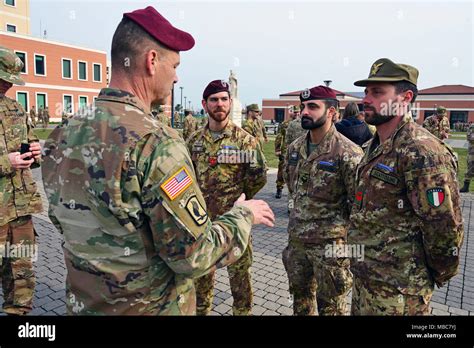 Command Sgt. Maj. Franklin Velez of the 173rd Airborne Brigade (left), congratulates Italian ...