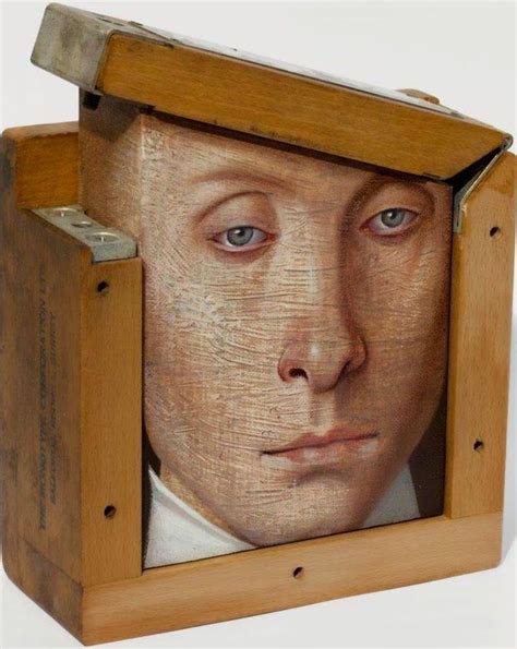 a wooden box with a painting of a man's face in it