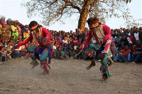 Traditional Nyau dancers with face masks at a Gule Wamkulu ceremony... | Native north americans ...