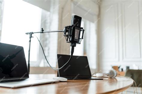 Premium Photo | A microphone in the radio studio and computers on the table