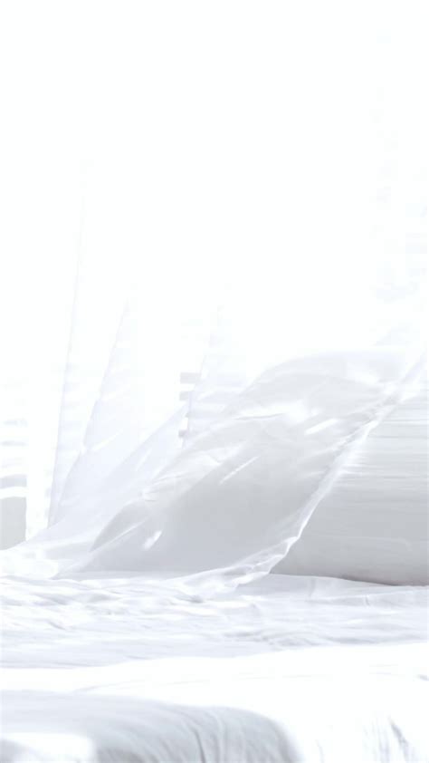 a white bed with pillows and a lamp 32353065 Stock Video at Vecteezy