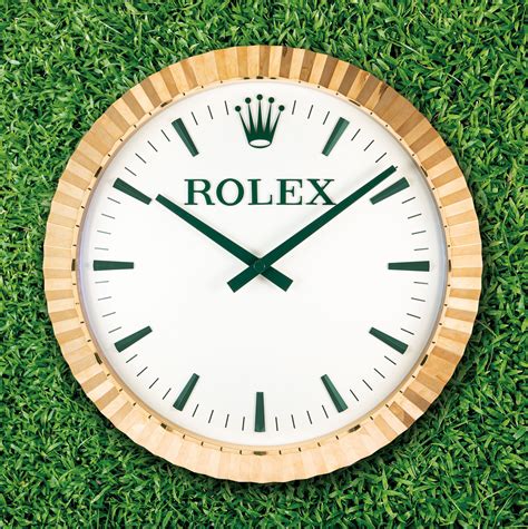 INDUCTA FOR ROLEX. A LARGE AND UNUSUAL GILT METAL QUARTZ WALL CLOCK