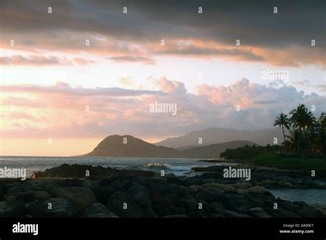 Tropical island sunset Stock Photo - Alamy