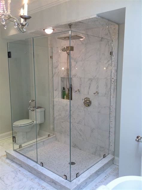 Square brass rain shower head over marble herringbone shower floor transitional bathroom – Artofit