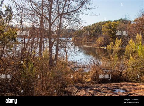 Texas Hill Country hiking trail with a view of Inks Lake. The autumn ...