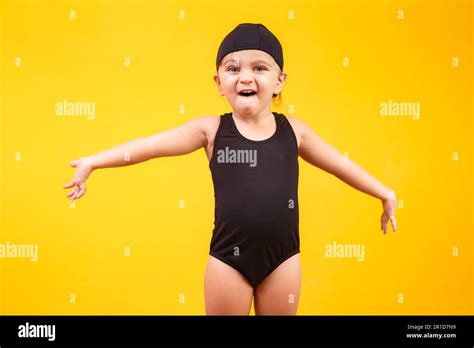 Little girl wearing beach outfit on yellow background. Summer and ...