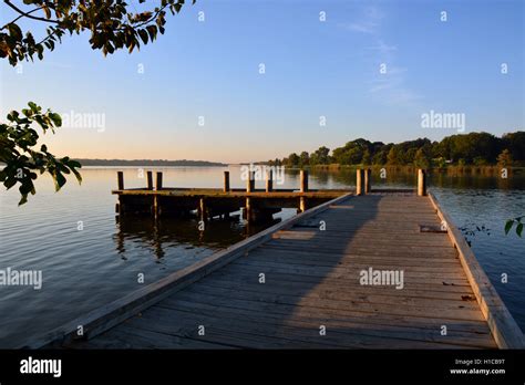 The sun rises over a fishing pier on White Rock Lake in Dallas Texas ...