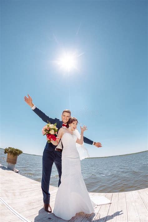 Young Wedding Couple on Pier Stock Photo - Image of kiss, dress: 70283226