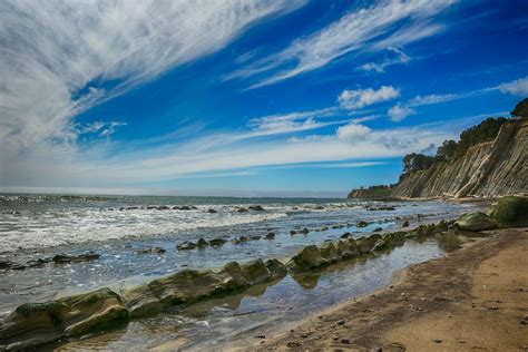 Gray Rocks on Seashore Under Blue Sky · Free Stock Photo