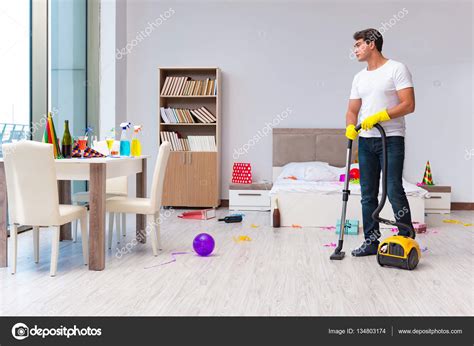 Man cleaning the house after christmas party — Stock Photo © Elnur_ #134803174